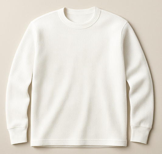 White ribbed sweater on a beige background