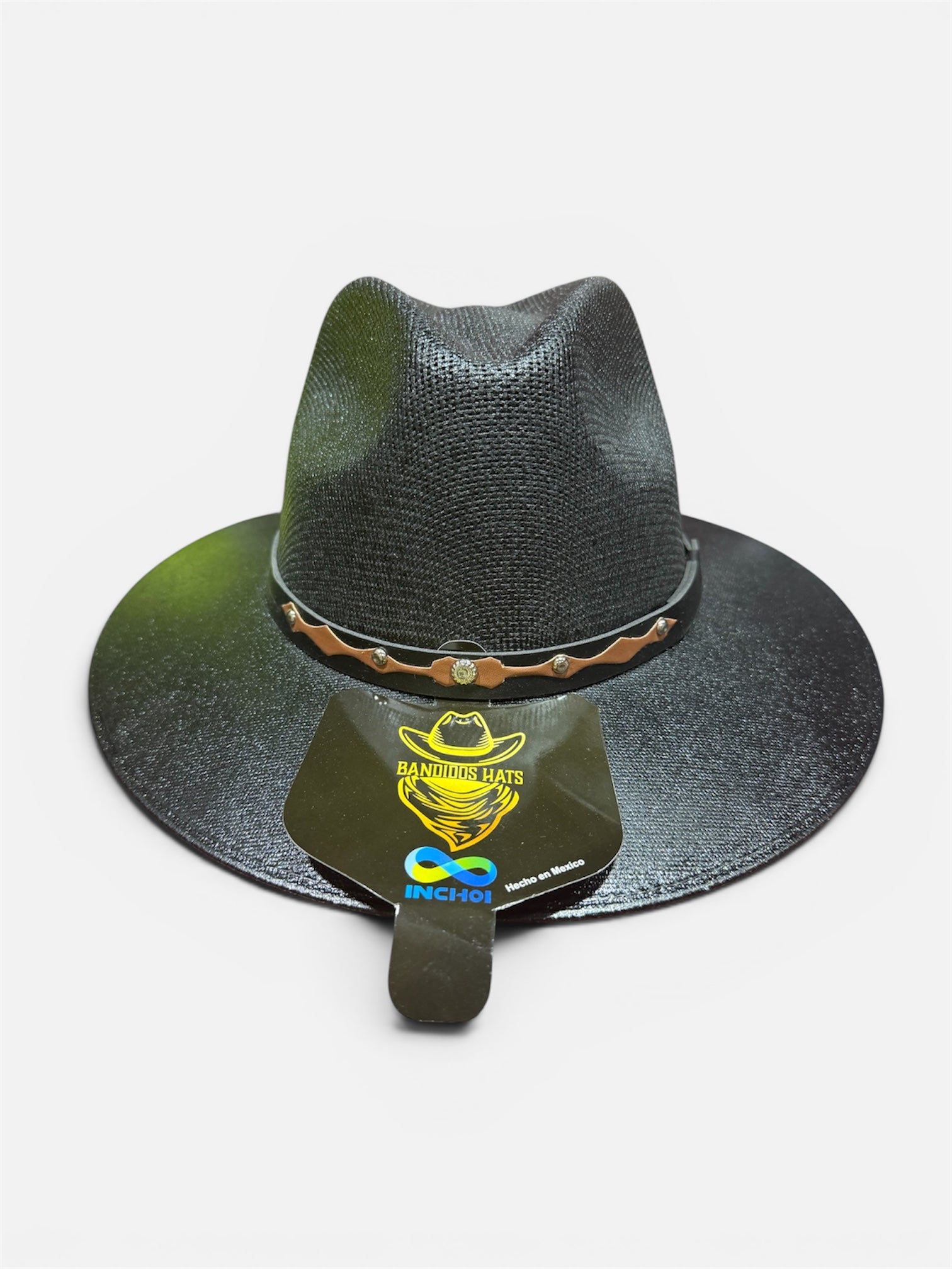 Black straw hat with decorative band on a white background