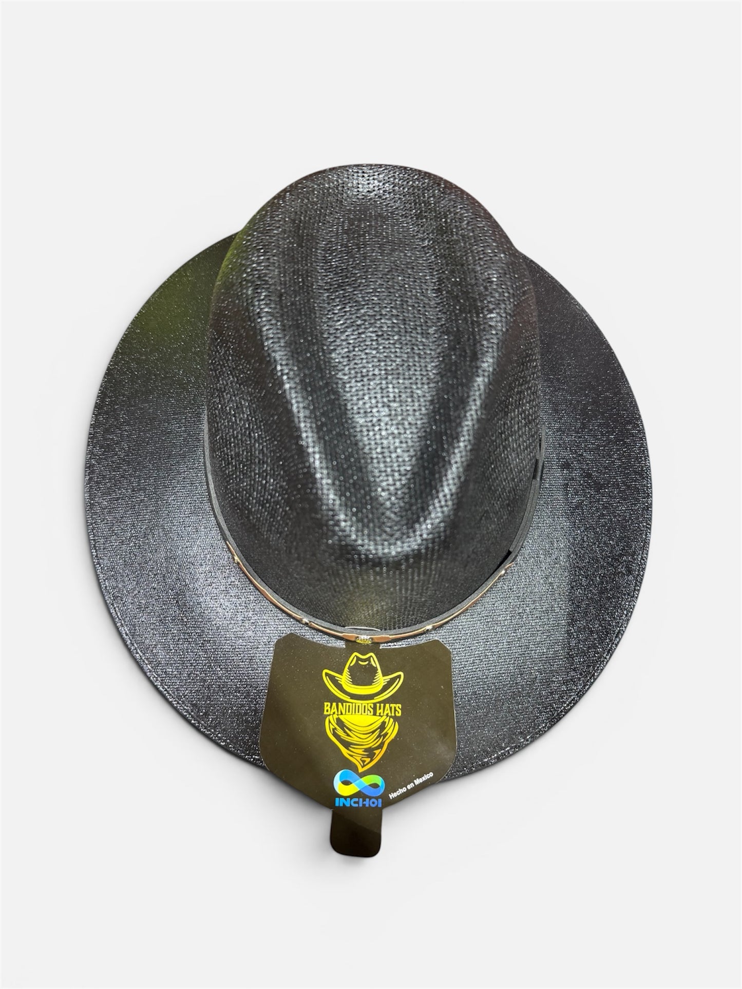 Black cowboy hat with a brand tag on a white background