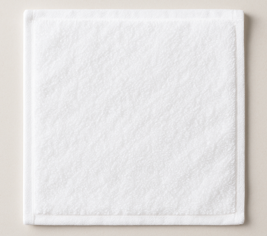 White textured square face towel on a beige background