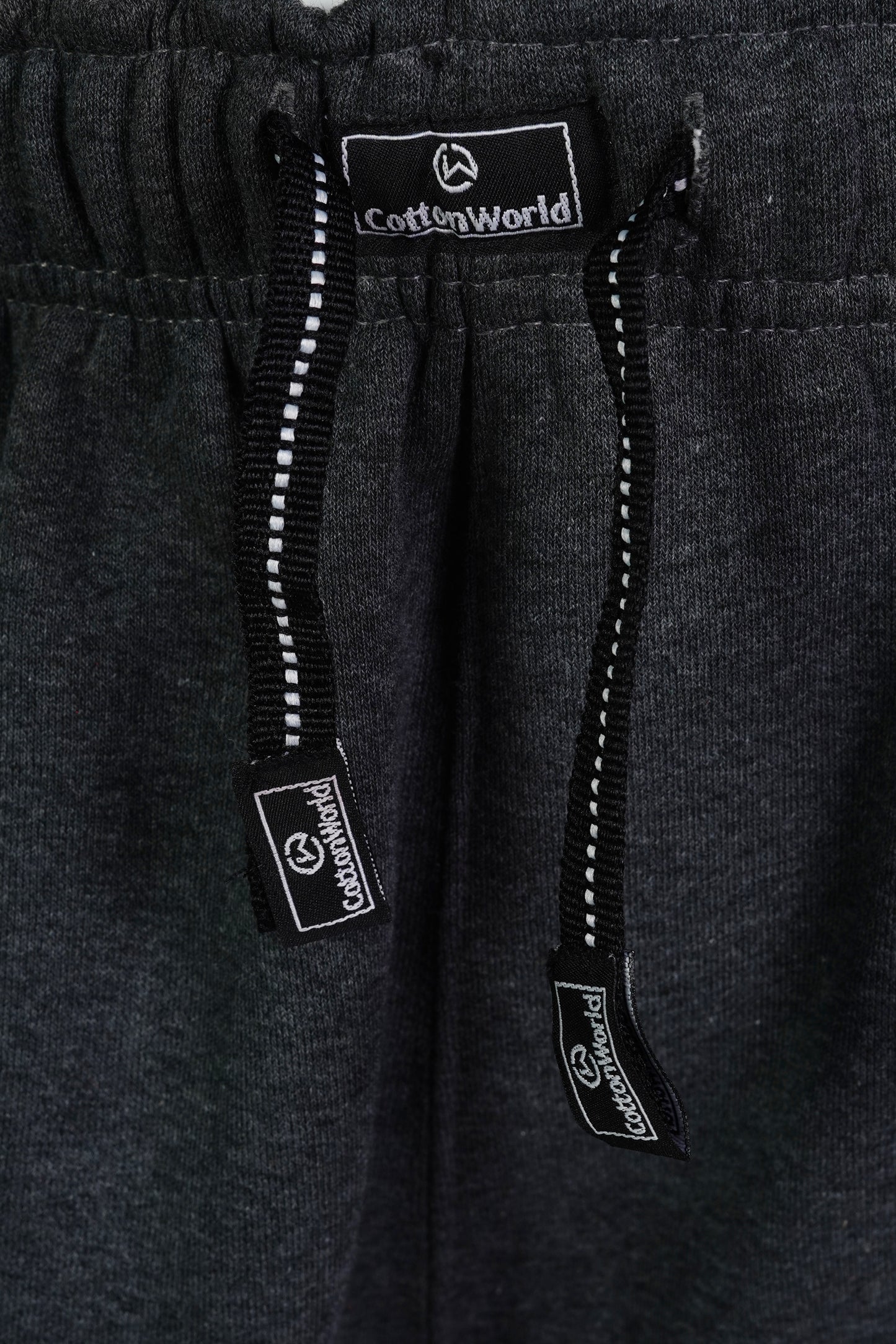 cotton world branded drawstrings attached to charcoal colored heavy jogger pants