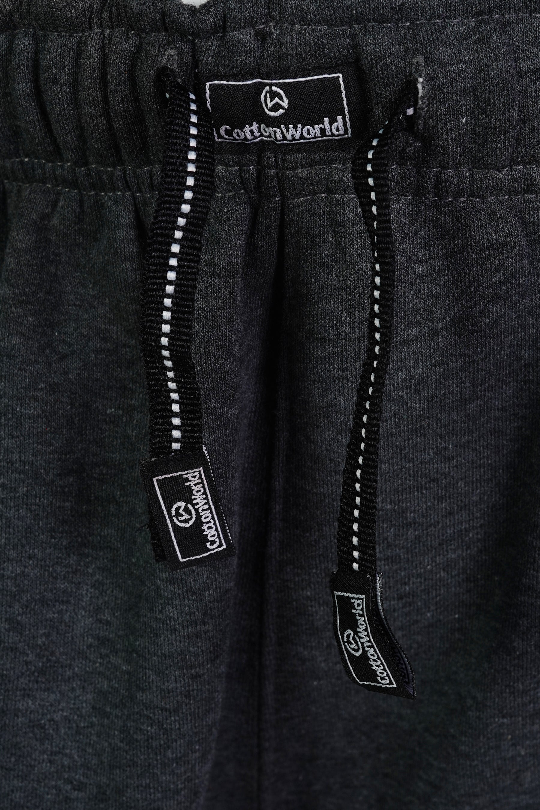 cotton world branded drawstrings attached to charcoal colored heavy jogger pants