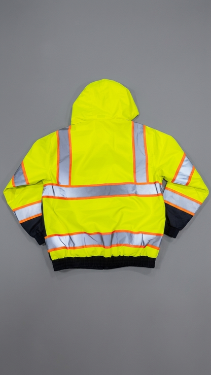 High-visibility safety jacket with reflective stripes on a gray background