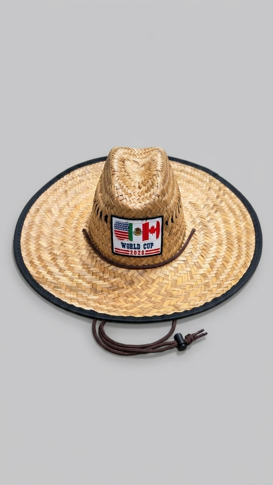 A woven straw cowboy hat with a black brim edge and a drawstring, featuring a front patch that reads 'WORLD CUP 2022' with Canadian flags, shown on a plain gray background.