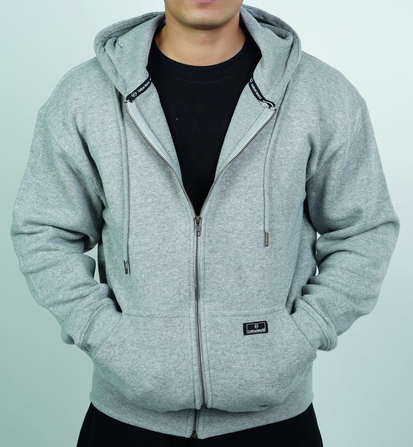 person wearing gray colored thermal lined zipper hoodie