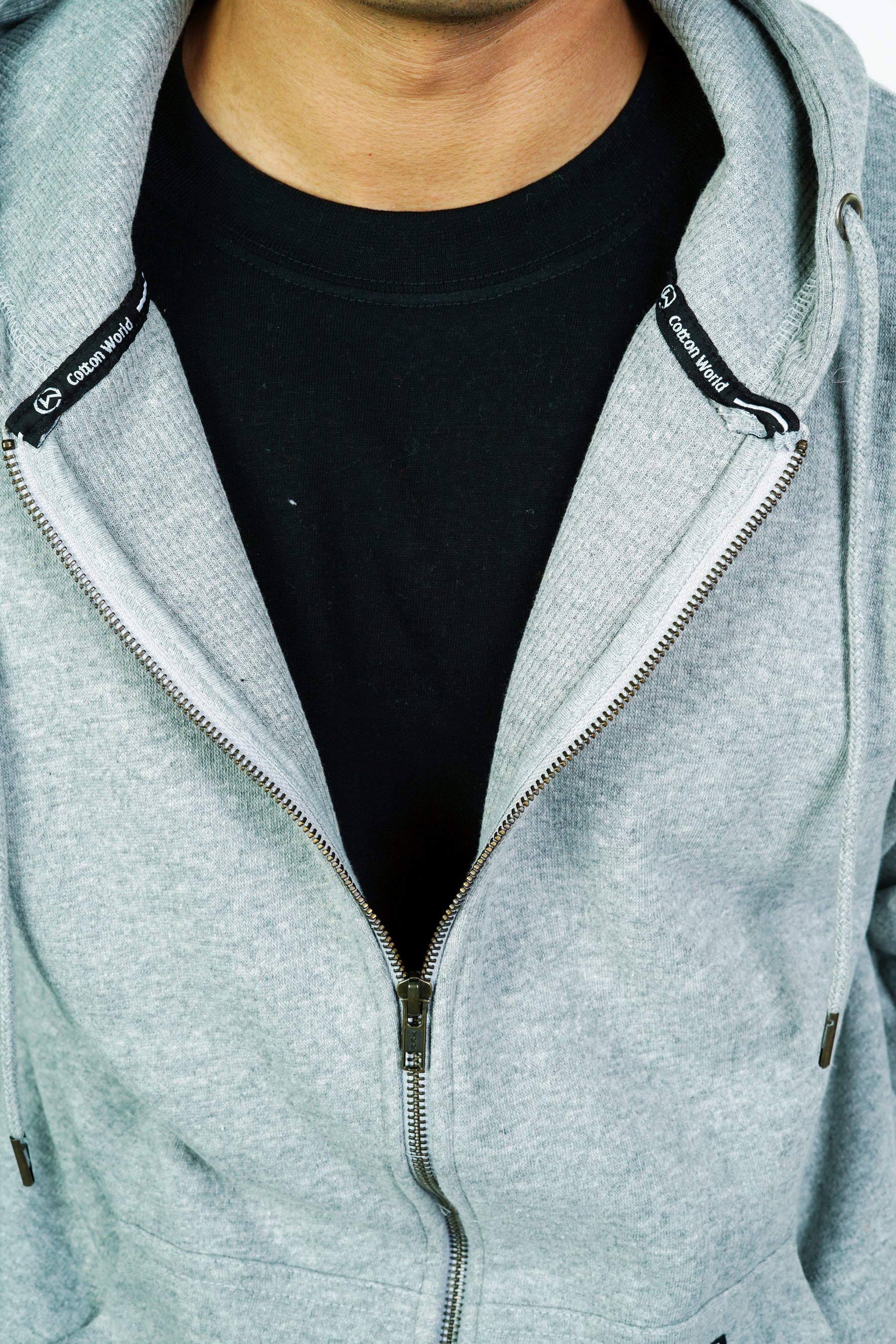 close up of a person wearing gray colored thermal lined zipper hoodie
